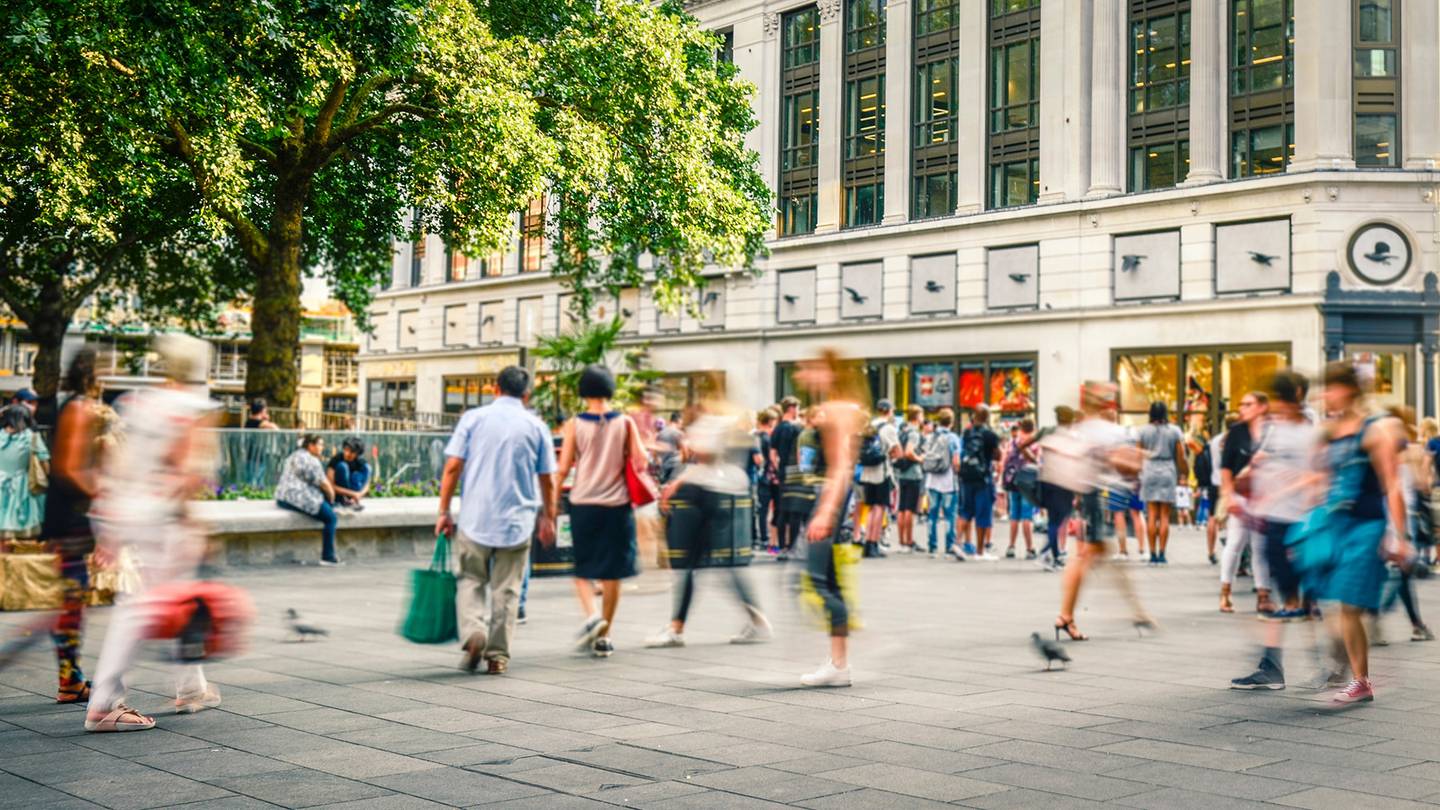 Pedestrians on a busy retail corridor.